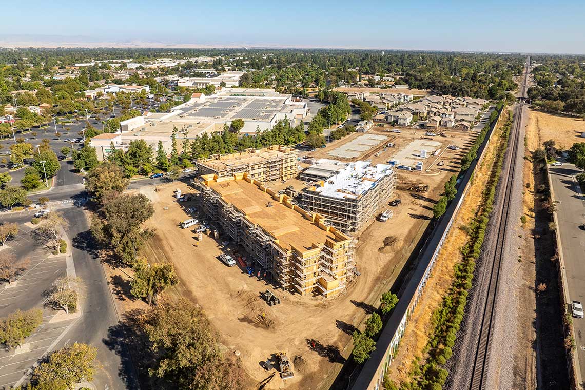 Affordable housing construction by Huff Construction in Merced, CA, with framed apartment buildings at Devonwood project in Central Valley