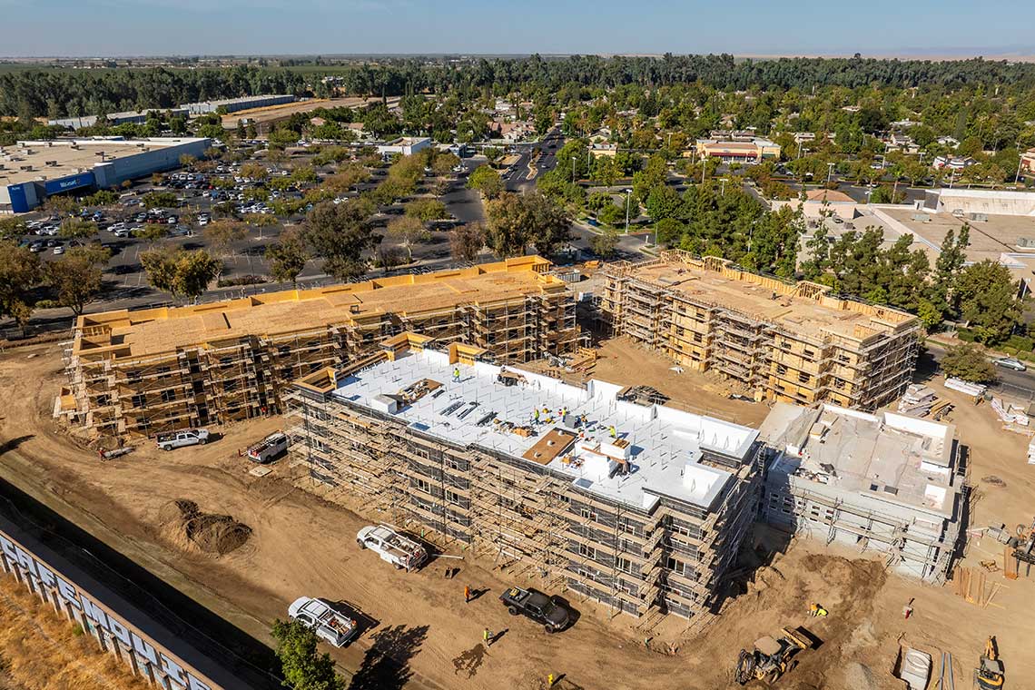 Roofing and rough plumbing installation on affordable housing units at Devonwood project, Huff Construction general contractor, Merced, CA